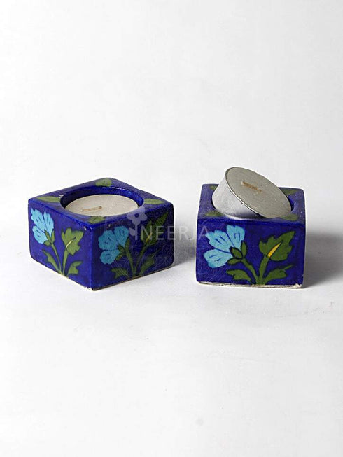 Turquoise Flower With Green Leaves on Blue Base